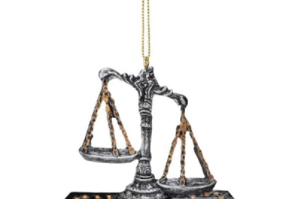 Unbalanced scales of Justice sitting on law books